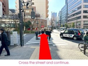 Cross the street and continue.